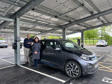 Cllr Brian Milnes and Cllr Bridget Smith underneath a solar car port at South Cambs Hall.