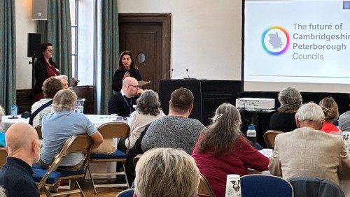 Cllr Bridget Smith speaking to a crowd of local residents inside the small hall at the Guildhall in Cambridge city centre.