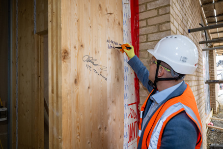 Leader Cllr Henry Batchelor signing the board Northstowe Unity Centre