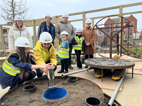 Young people burying the time capsule
