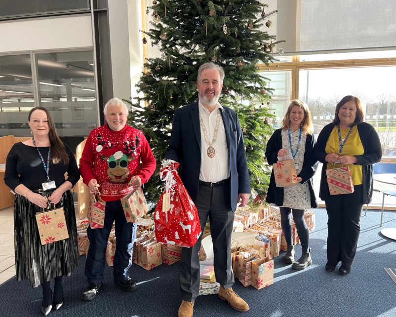 Councillor Peter Fane and staff presenting the Christmas presents for patients at Fulbourn hospital